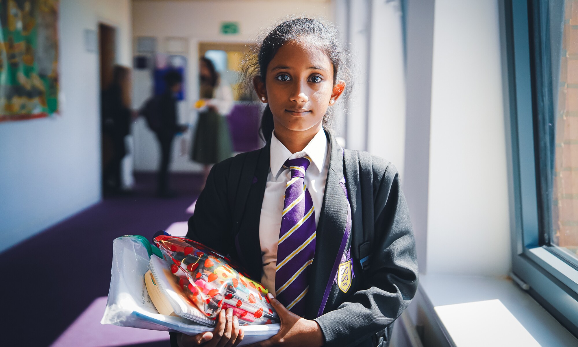 Pupil in corridor with equipment